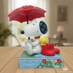 Calma de chaparrón con ternura Peanuts: Snoopy & Woodstock – Just a Rainy Day reúne a los inseparables amigos en una escena acogedora, con Snoopy resguardándolos bajo un paraguas en forma de hoja