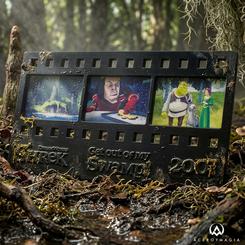 Un fragmento de celuloide convertido en metal tiene más presencia de la que parece: esta réplica tira de película Shrek condensa tres escenas reconocibles en un formato compacto, negro y con relieve. 