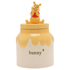 Tarro de almacenamiento de cerámica con figura de Winnie the Pooh sobre la tapa. Mide 20x12x12 cm y presenta el diseño clásico del tarro de miel "hunny" con detalles de Disney.
